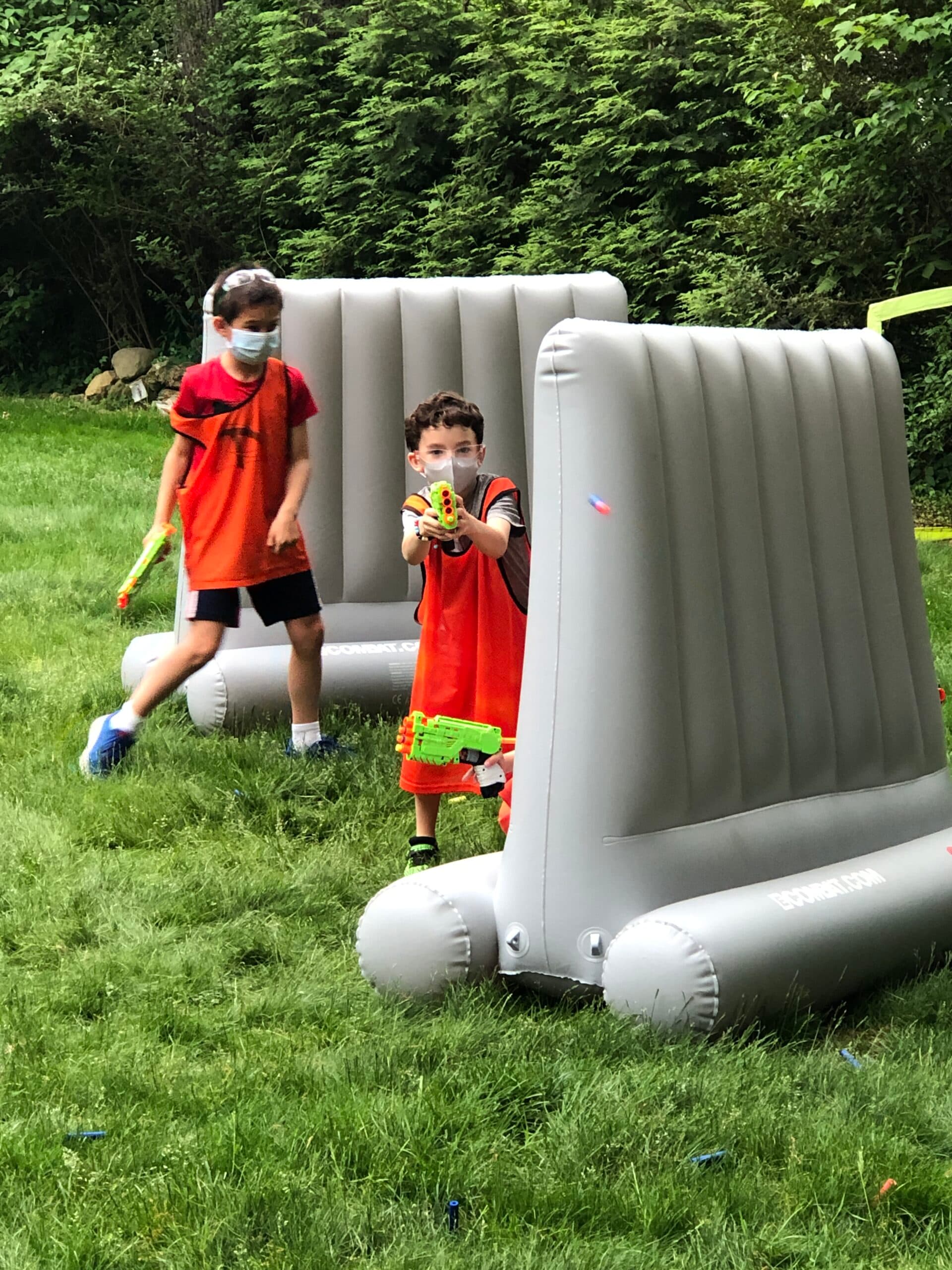 Kids playing nerf war outdoors